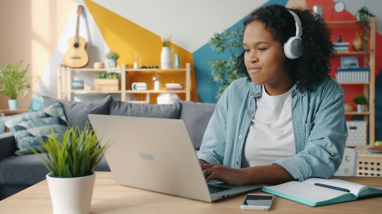A learner working on a laptop at home